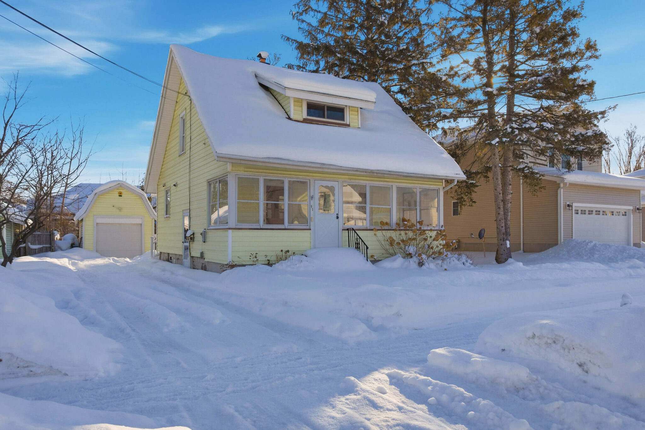 Snow-covered house in winter landscape