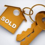 Gold sold keychain and house keys representing a successful home sale in Monroe County NY