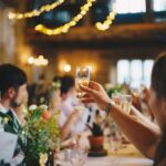 People raising champagne glasses in a toast at a festive indoor gathering in Monroe County