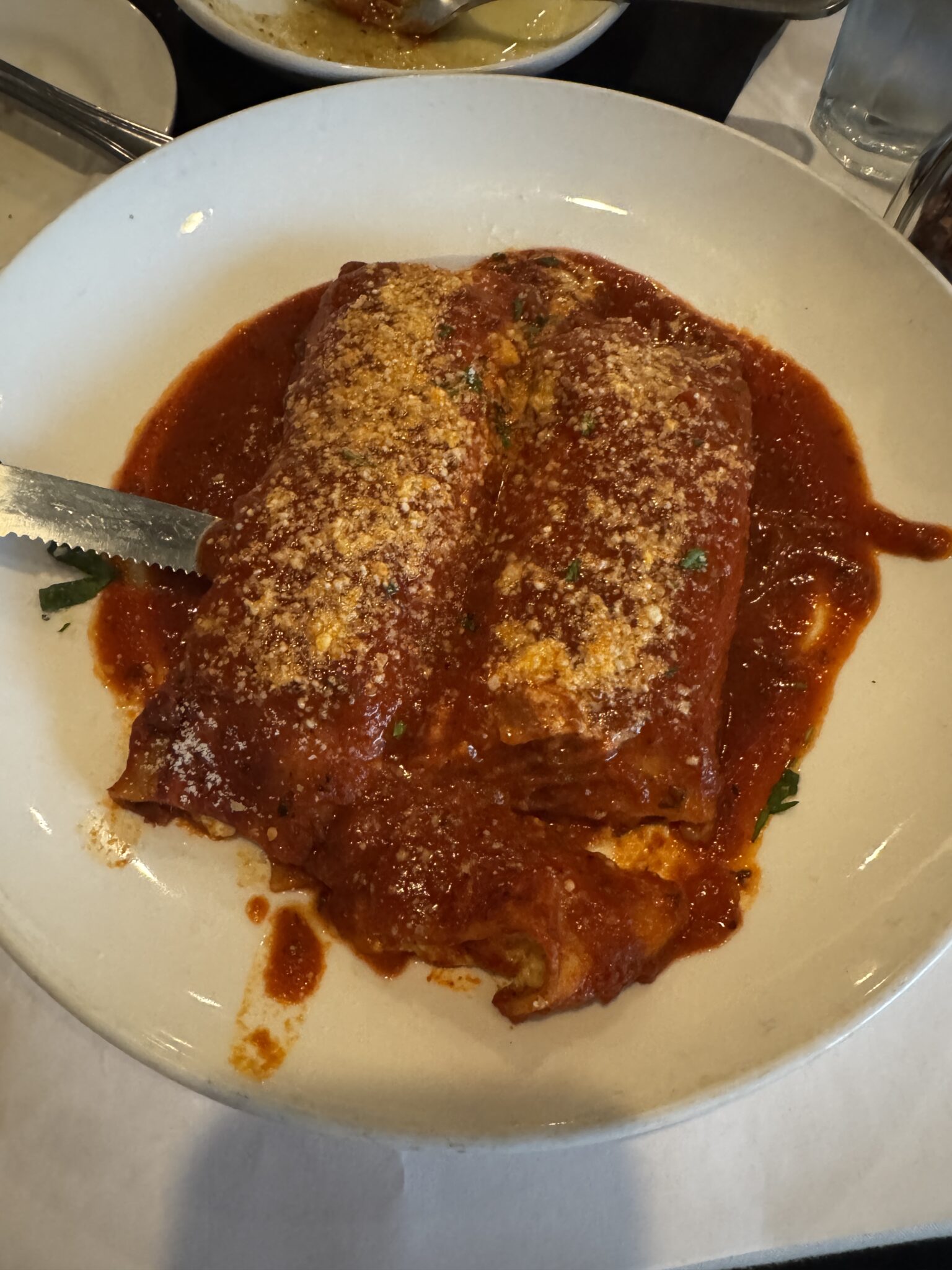 Two enchiladas with red sauce